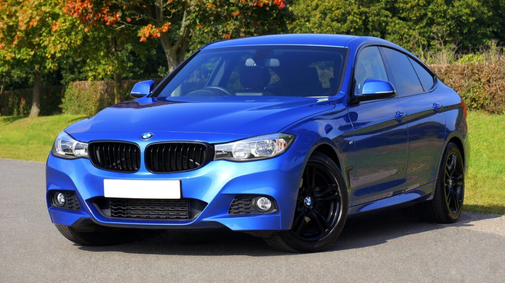 pexels photo 170811 170811 Modern blue luxury car parked by a scenic roadside on a sunny day. Stylish design.